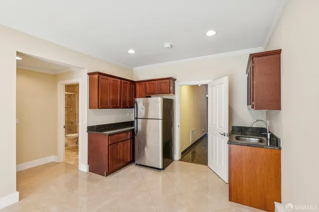 a kitchen with stainless steel appliances granite countertop a refrigerator and a stove
