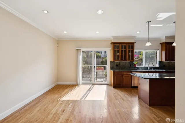 a bathroom with a granite countertop sink mirror toilet and bathtub