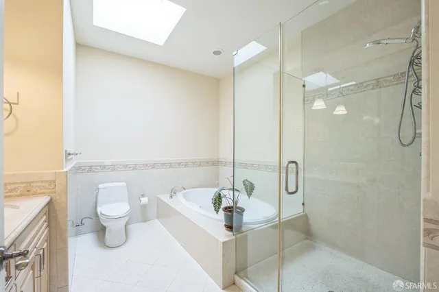 a bathroom with a sink vanity granite and toilet
