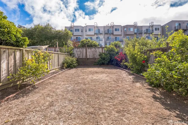 a view of a garden with a building in the background