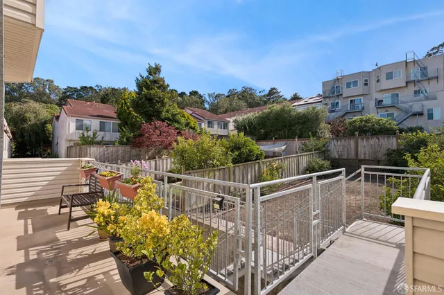 a view of balcony with outdoor seating and city view