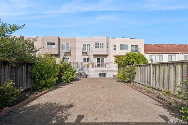 a view of a room with wooden floor and chandelier