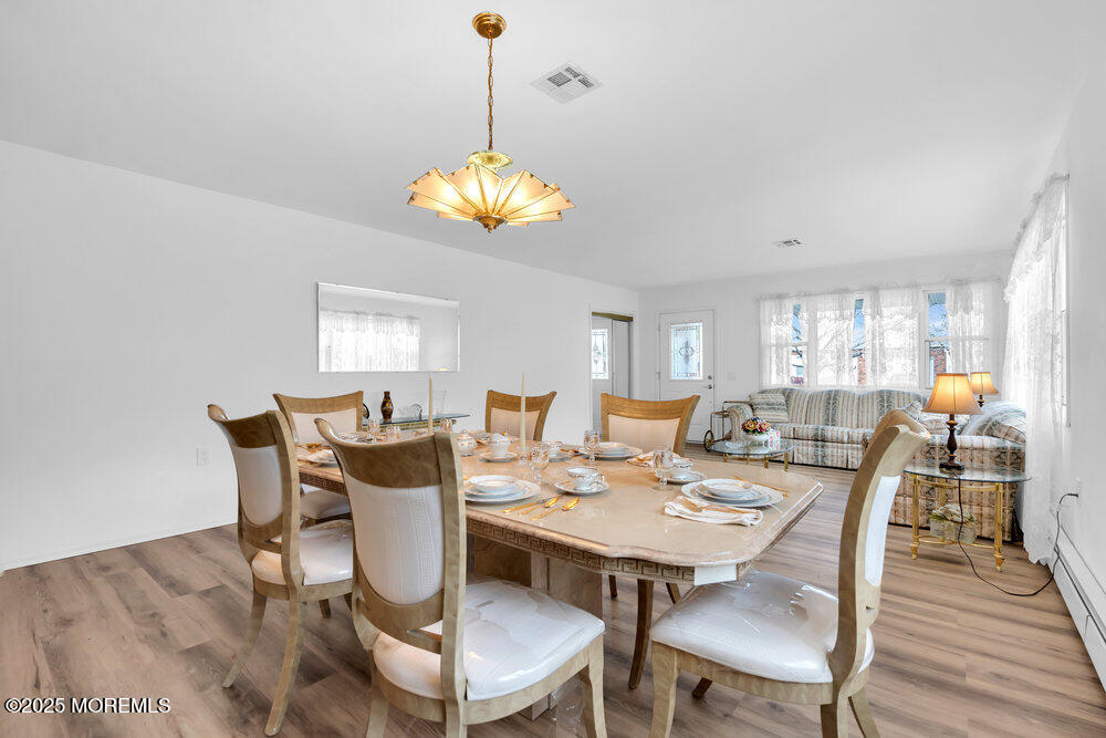 148 Davenport Road Toms River, NJ 08757 - Photo 12 of 49 a view of a dining room with furniture wooden floor and chandelier