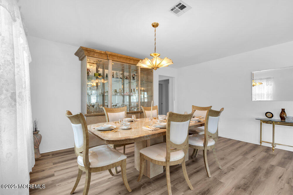 148 Davenport Road Toms River, NJ 08757 - Photo 13 of 49 a dining room with furniture a chandelier and wooden floor