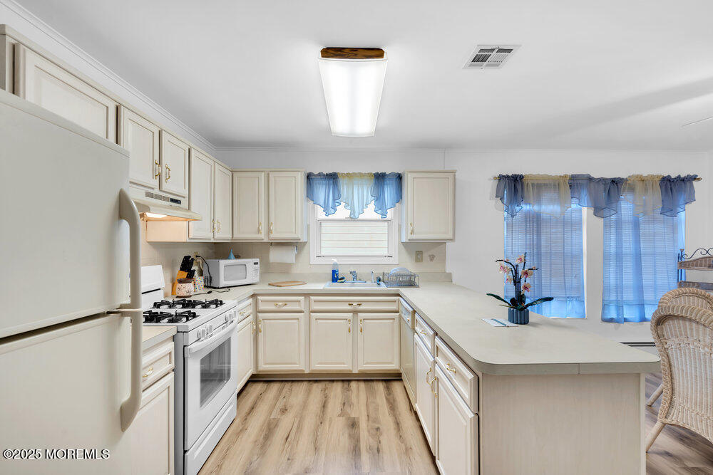148 Davenport Road Toms River, NJ 08757 - Photo 17 of 49 a kitchen with a sink a stove a refrigerator and white cabinets