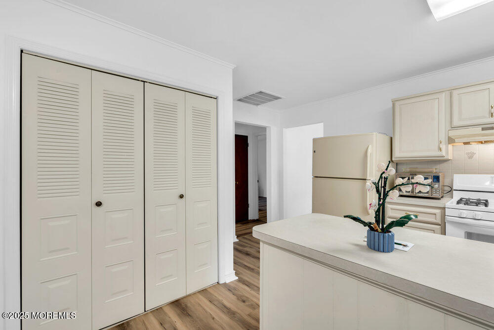 148 Davenport Road Toms River, NJ 08757 - Photo 18 of 49 a kitchen with a refrigerator and white cabinets