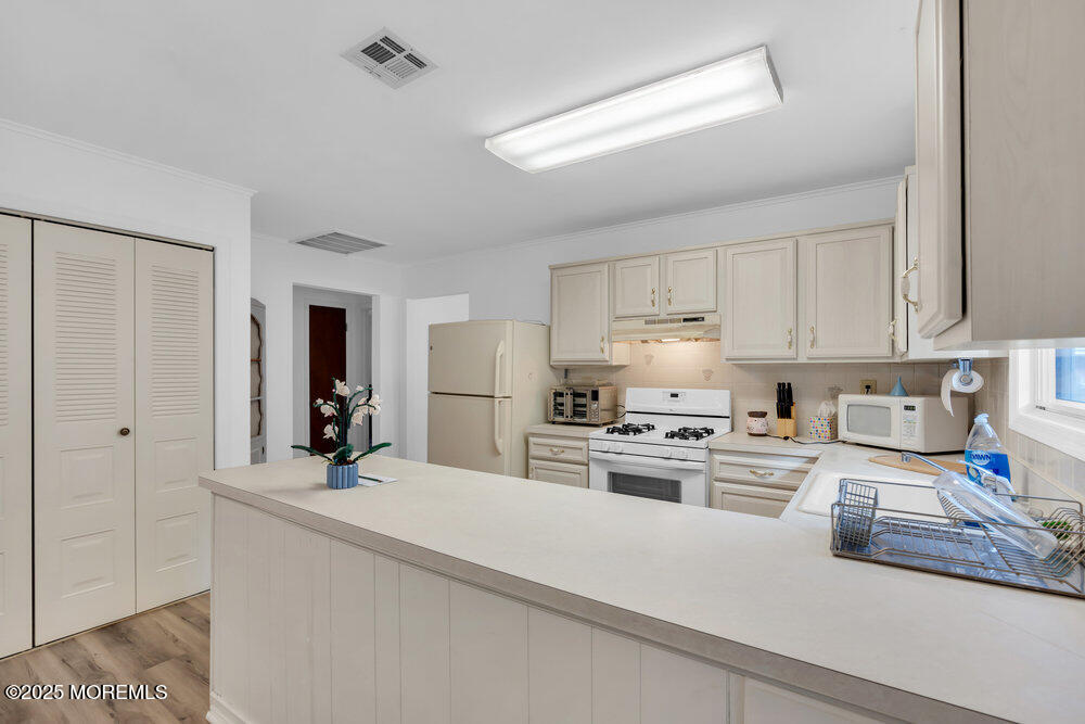 148 Davenport Road Toms River, NJ 08757 - Photo 19 of 49 a kitchen with kitchen island a stove a sink and a refrigerator