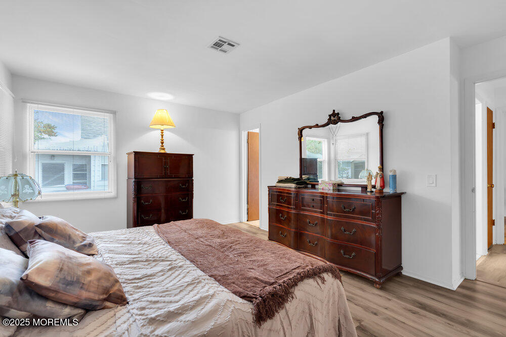 148 Davenport Road Toms River, NJ 08757 - Photo 28 of 49 a bedroom with a bed and a mirror on dresser