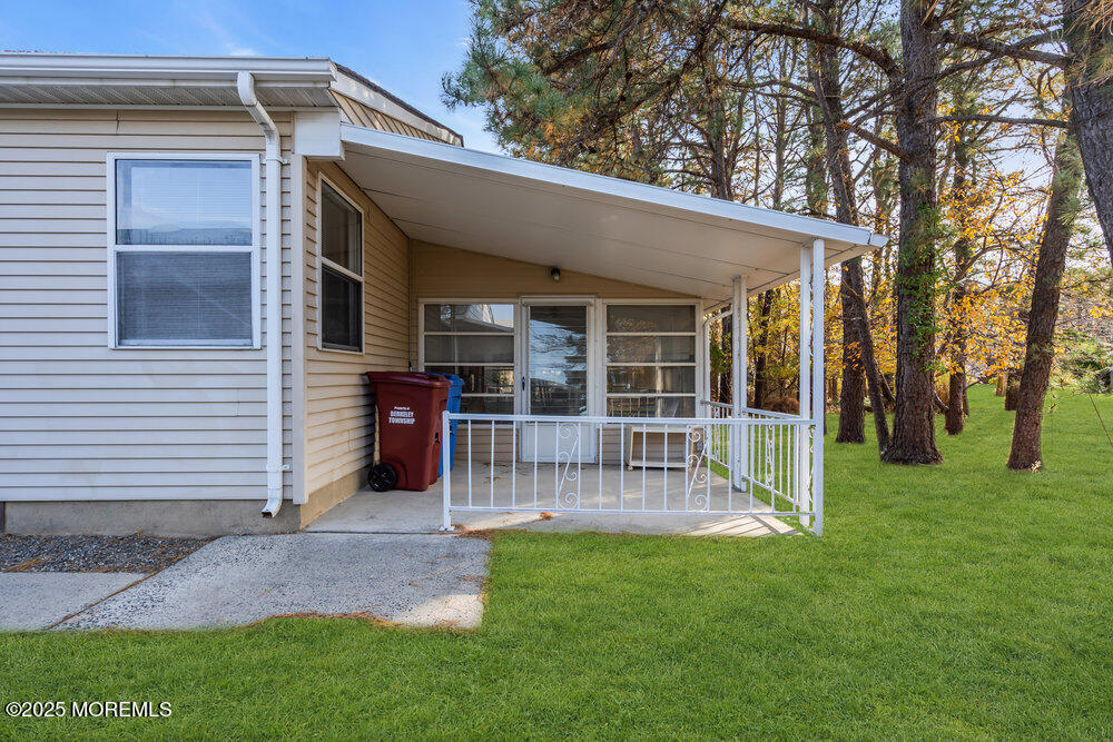 148 Davenport Road Toms River, NJ 08757 - Photo 35 of 49 a view of a house with a patio and a yard