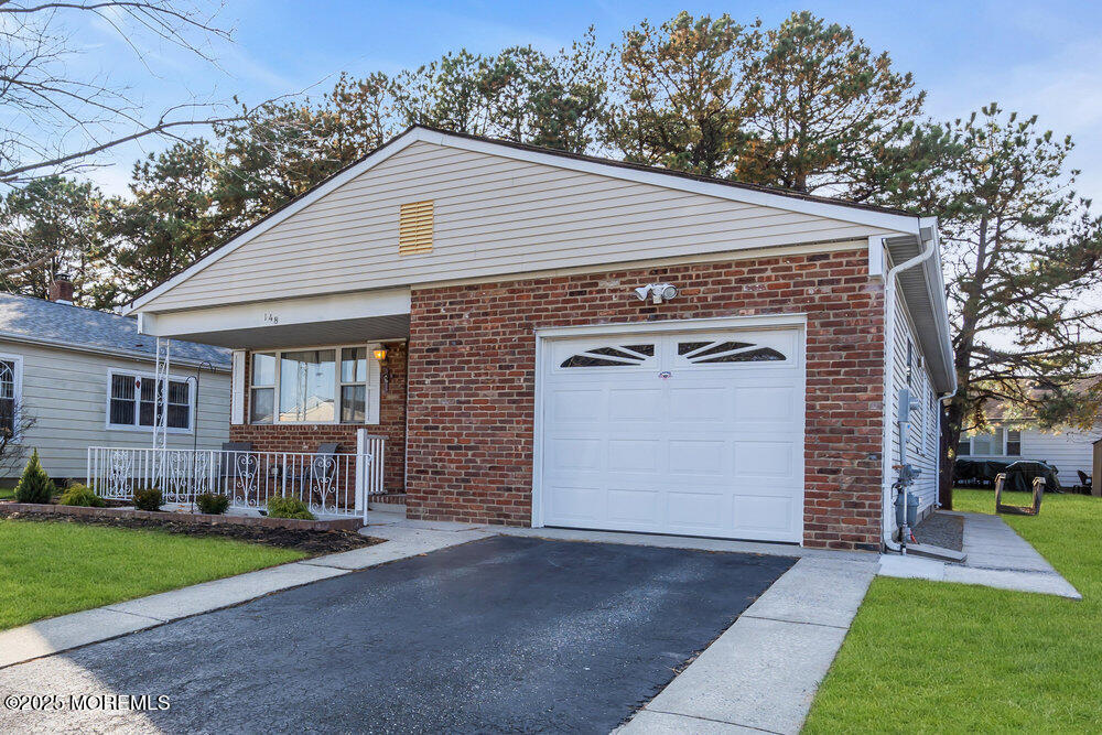 148 Davenport Road Toms River, NJ 08757 - Photo 42 of 49 a front view of a house with a yard and garage