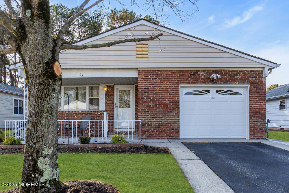 148 Davenport Road Toms River, NJ 08757 - Photo 47 of 49 a front view of a house with a garden and yard