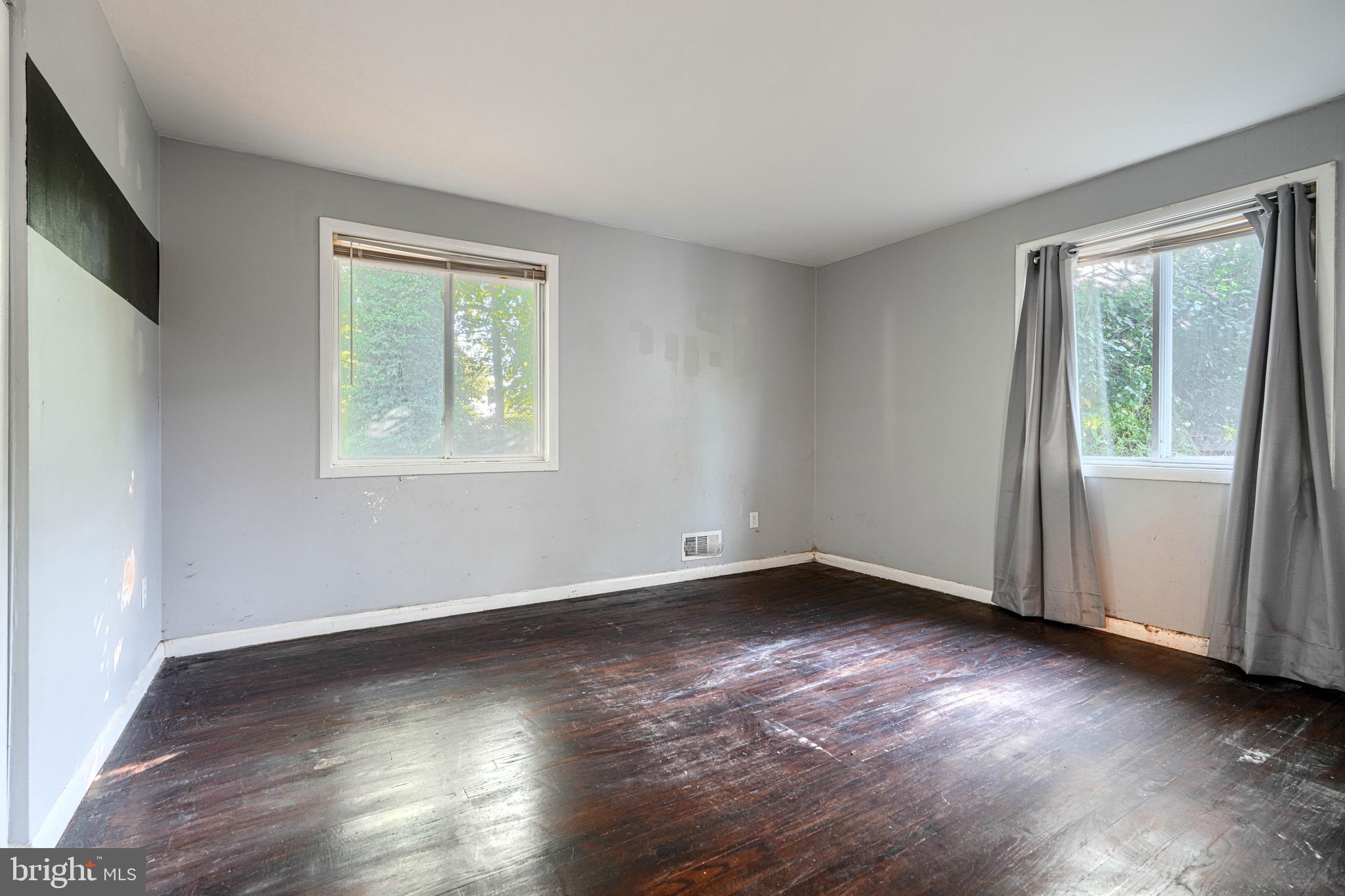 9706 Liberty Road Randallstown, MD 21133 - Photo 26 of 43 a view of an empty room with wooden floor and a window