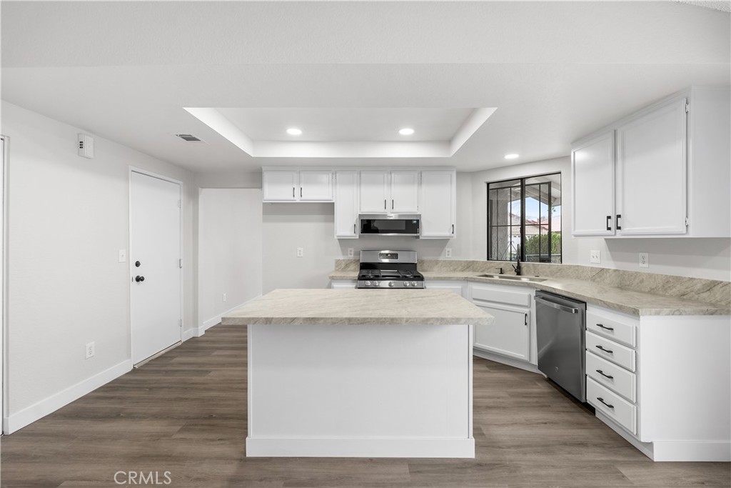 3563 East Ave R-11 Palmdale, CA 93550 - Photo 13 of 36 a kitchen with stainless steel appliances a sink stove top oven and cabinets