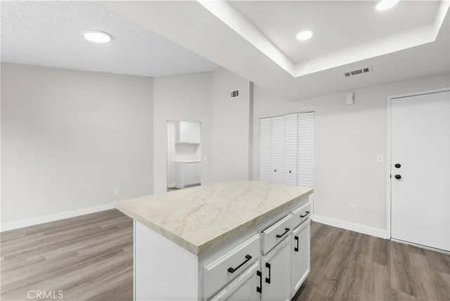 a kitchen with a wooden floor and window