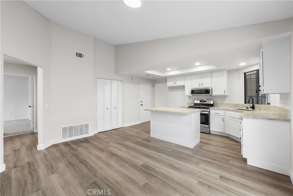 3563 East Ave R-11 Palmdale, CA 93550 - Photo 17 of 36 a kitchen with granite countertop a sink cabinets and wooden floor