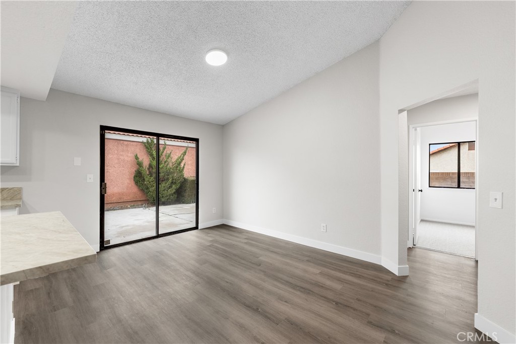 3563 East Ave R-11 Palmdale, CA 93550 - Photo 19 of 36 an empty room with wooden floor and windows