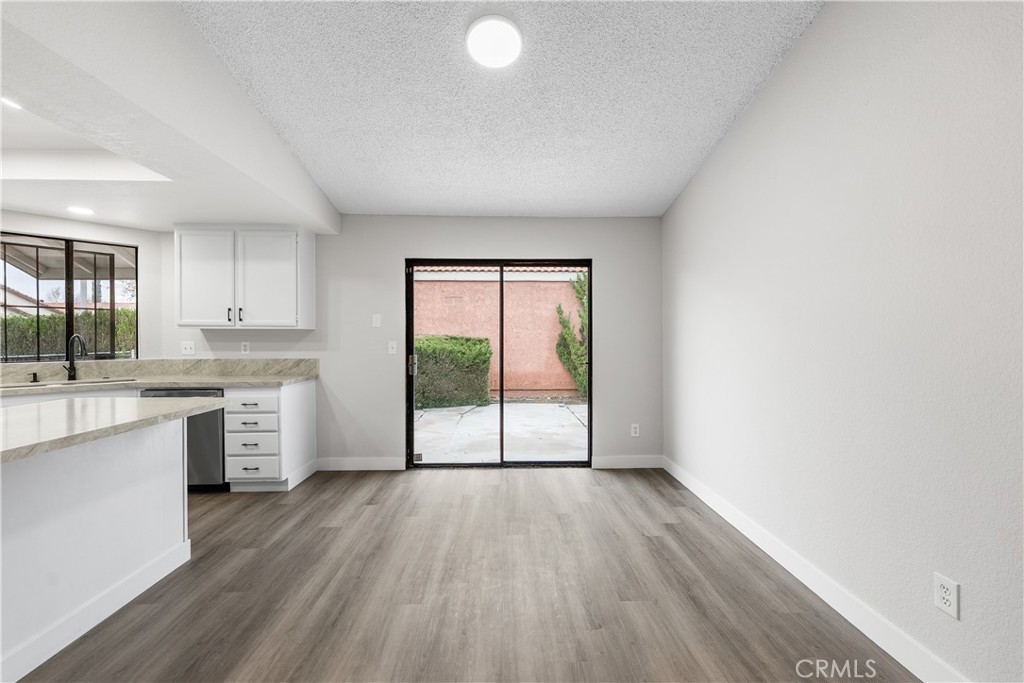 3563 East Ave R-11 Palmdale, CA 93550 - Photo 20 of 36 a open kitchen with a large window a sink and white appliances
