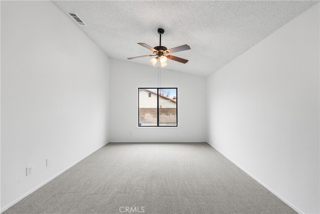 3563 East Ave R-11 Palmdale, CA 93550 - Photo 22 of 36 an empty room with windows and fan