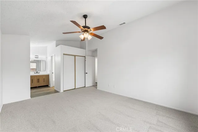 a view of empty room with a ceiling fan and window