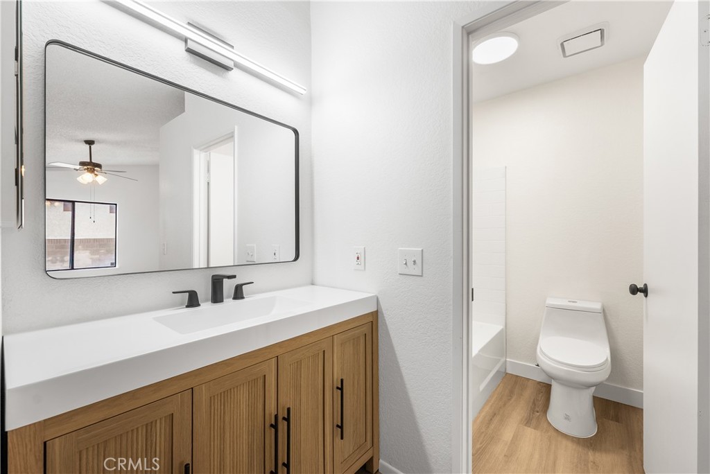 3563 East Ave R-11 Palmdale, CA 93550 - Photo 25 of 36 a bathroom with a sink a toilet and a mirror