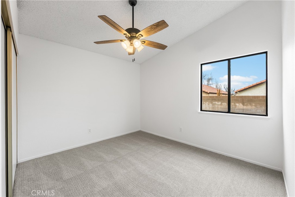 3563 East Ave R-11 Palmdale, CA 93550 - Photo 26 of 36 an empty room with a window and a fan