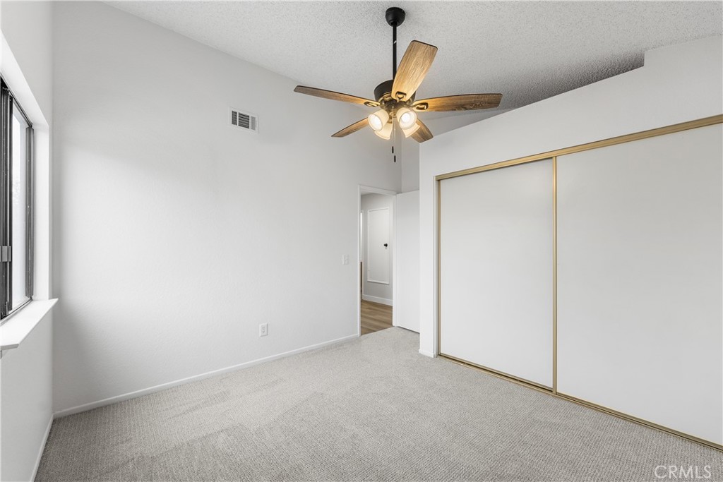 3563 East Ave R-11 Palmdale, CA 93550 - Photo 27 of 36 an empty room with a window and a fan