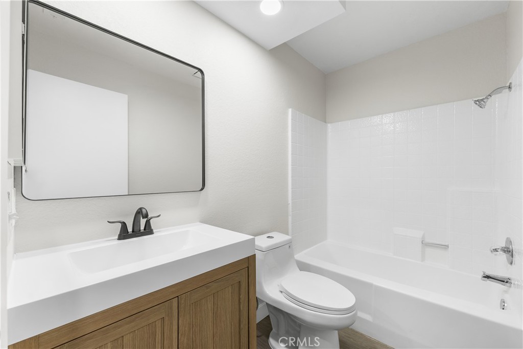 3563 East Ave R-11 Palmdale, CA 93550 - Photo 30 of 36 a bathroom with a sink a toilet and a mirror