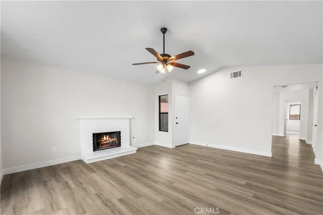 a view of a livingroom with a ceiling fan and wooden floor