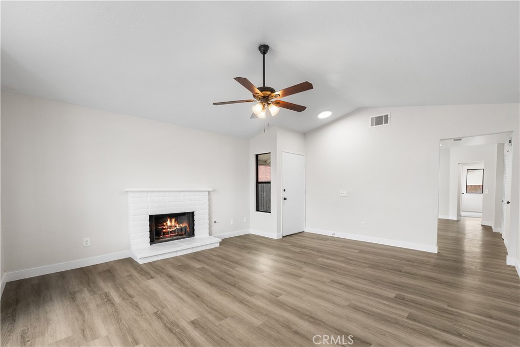 3563 East Ave R-11 Palmdale, CA 93550 - Photo 8 of 36 a view of a livingroom with a ceiling fan and wooden floor