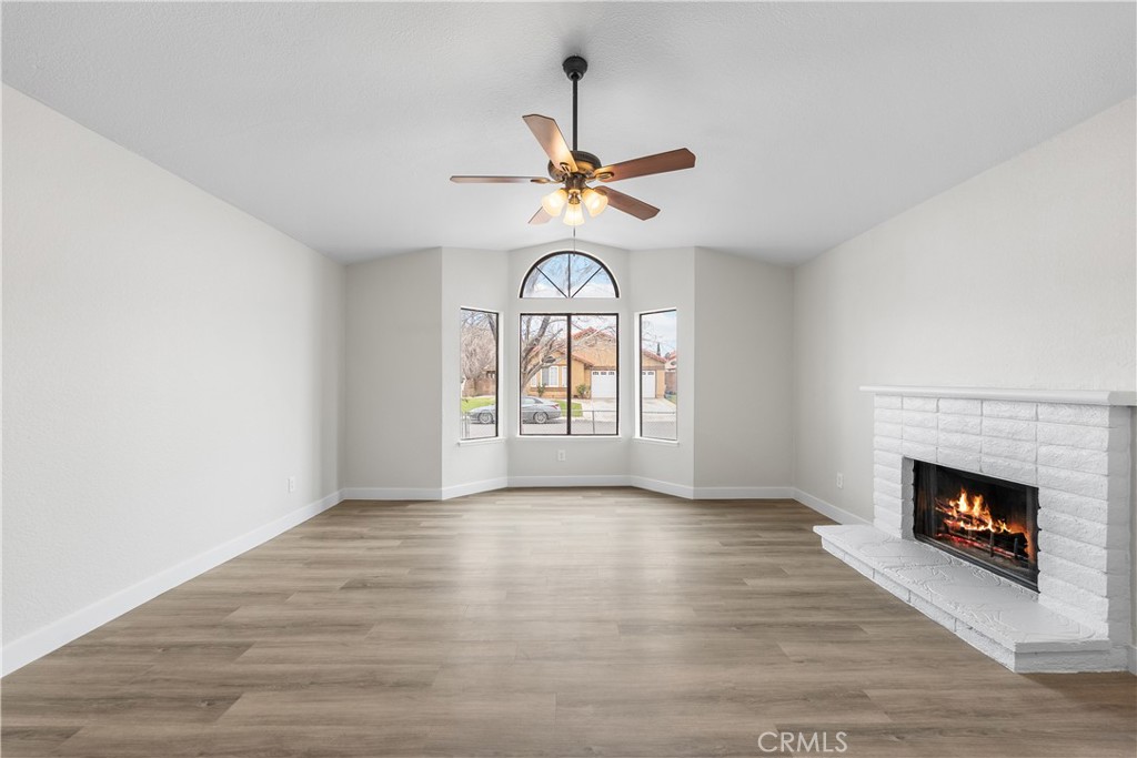 3563 East Ave R-11 Palmdale, CA 93550 - Photo 10 of 36 a view of an empty room with a fireplace and a window