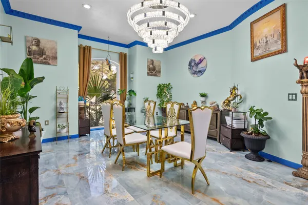a dining room with furniture and a chandelier