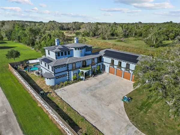 an aerial view of a house with a yard