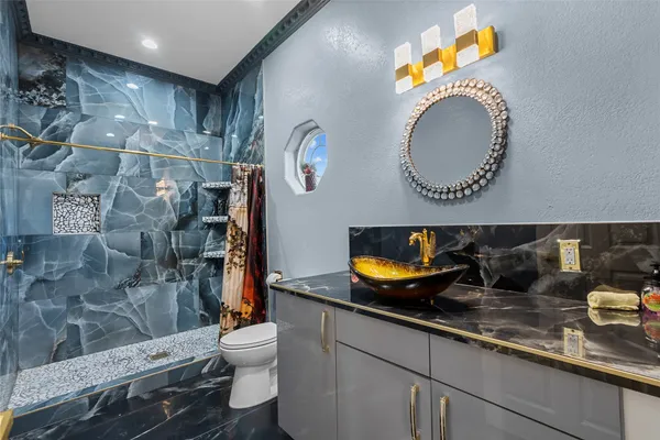 a bathroom with a sink a toilet and a mirror