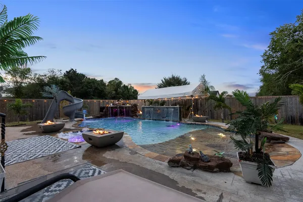 a view of a swimming pool with sitting area