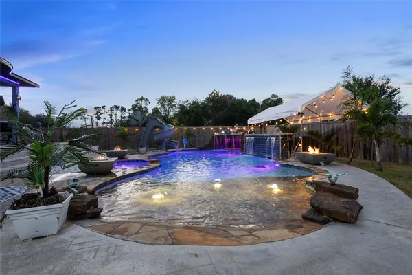 a view of a backyard with swimming pool