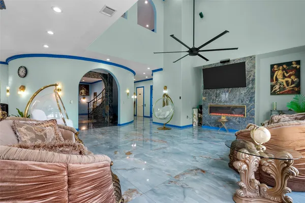 a living room with furniture a flat screen tv and a fireplace