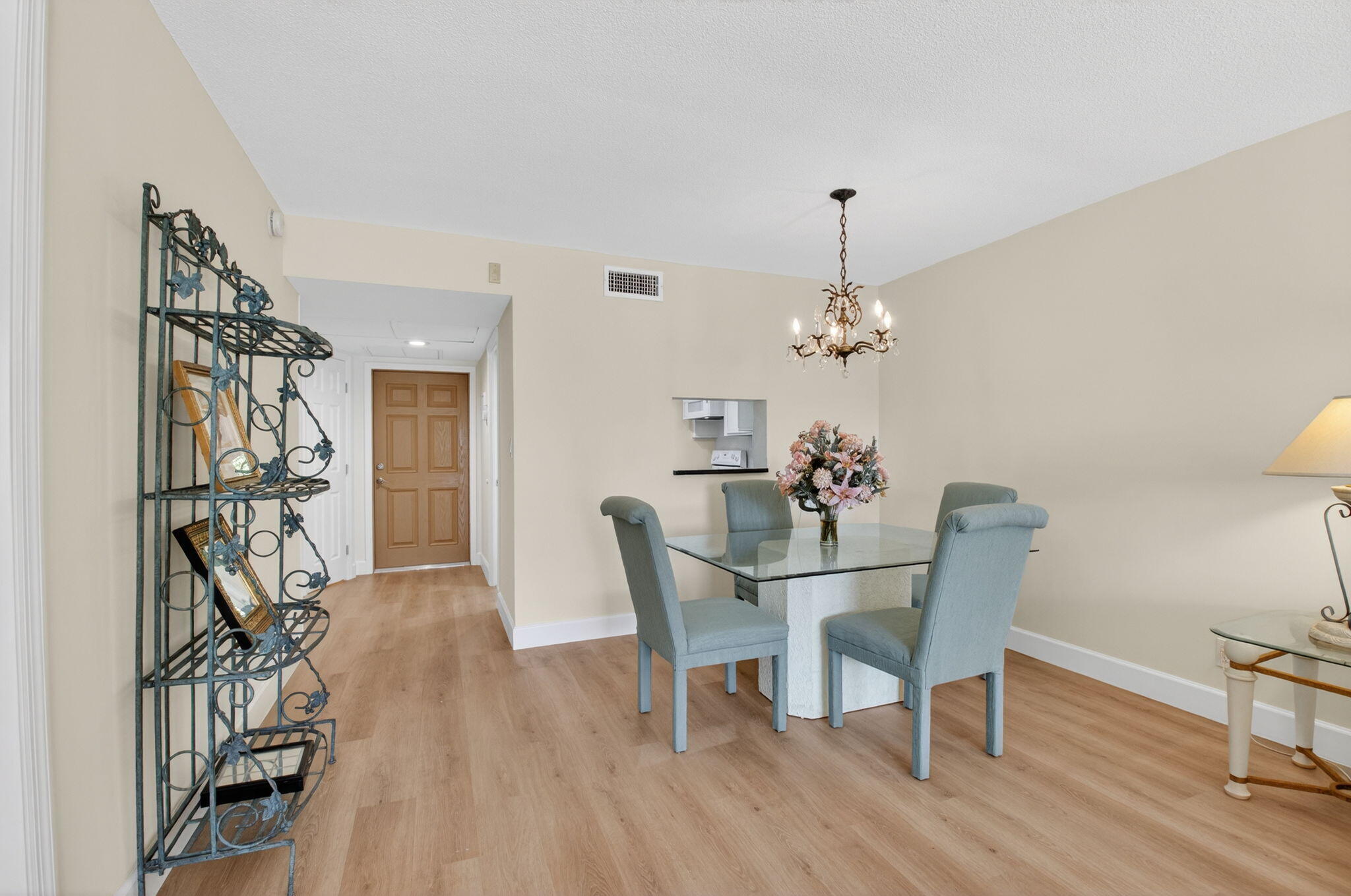 2871 North Ocean Boulevard, Unit V143 Boca Raton, FL 33431 - Photo 11 of 34 a dining room with furniture wooden floor a rug and a chandelier