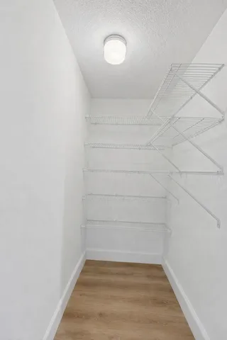 a spacious bedroom with a bed and a window