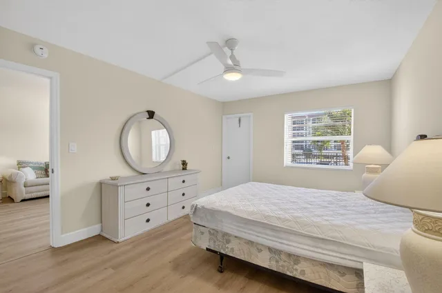 a bedroom with a bed and a mirror