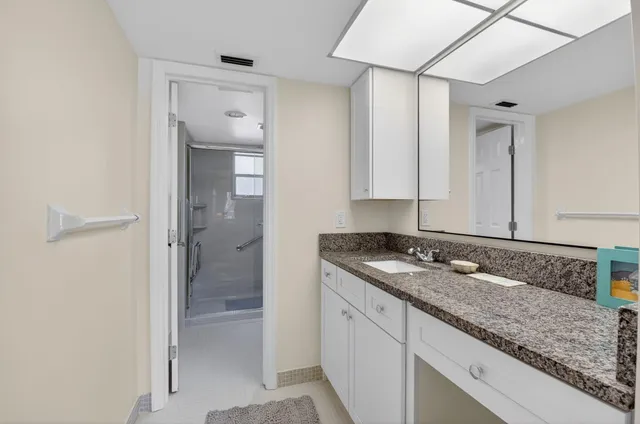 a bathroom with a shower a toilet and a shower