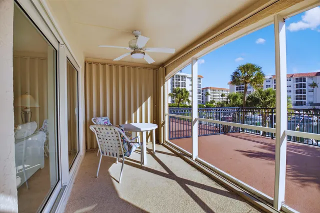 a view of a balcony with a floor to ceiling window and wooden fence