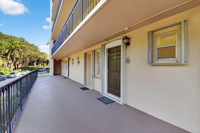 a view of a hallway to rooms