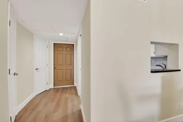 a kitchen with stainless steel appliances white cabinets and a stove top oven