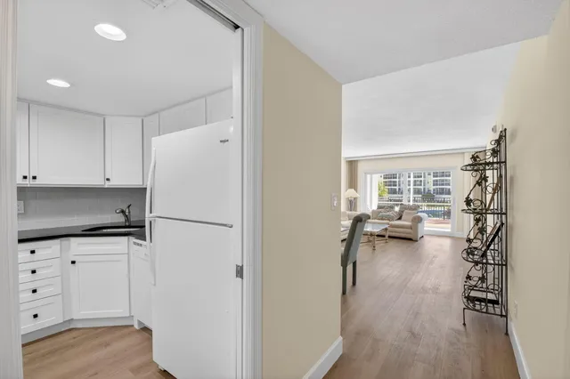 a dining room with furniture wooden floor a rug and a chandelier