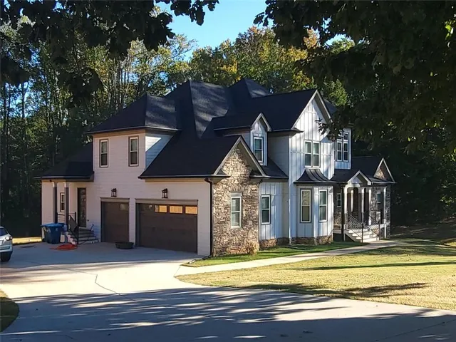a view of a house with a patio and a yard