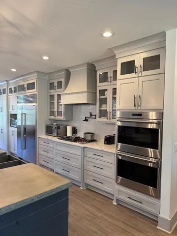 a kitchen with stainless steel appliances kitchen island wooden cabinets and stove
