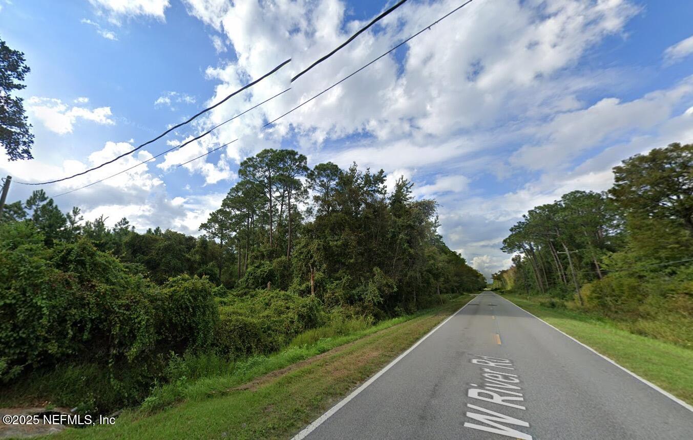 696 West River Road Palatka, FL 32177 - Photo 3 of 6 a view of a street with a yard