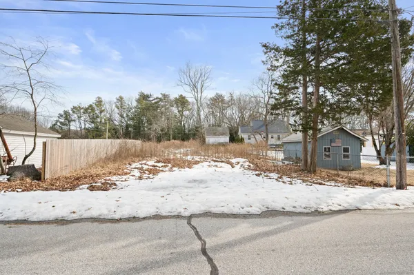a view of a house with snow on the road