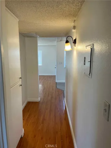 a view of a kitchen with wooden floor and electronic appliances