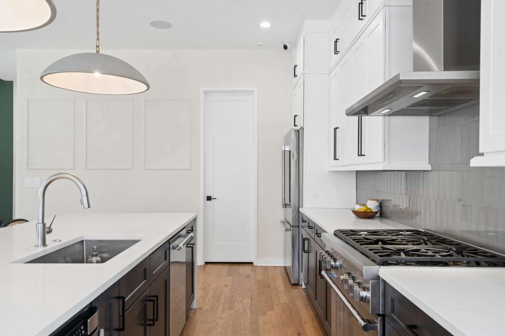 32 Walthall Street Northeast, Unit A Atlanta, GA 30307 - Photo 16 of 39 a kitchen with stainless steel appliances granite countertop a sink a stove and a wooden floors